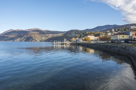 Extra wide angle view of the promenade on the lake in Luino with the mountains in the backgroundの写真素材