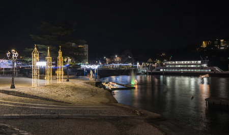 Laveno, Italy - 12-20-2022: Christmas crib submerged and illuminated by colored lights in the water of Lake Maggiore in Lavenoのeditorial素材