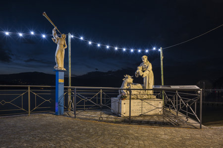 Laveno, Italy - 12-20-2022: Beautiful monument illuminated by Christmas lights with the lake in the background in Lavenoのeditorial素材