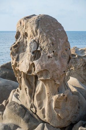 Wind-eroded rocks illuminated by the sun in the beautiful Punta Molentis beach in Villasimiusの写真素材