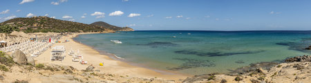Pula, Italy- 09-10-2024: Wide view of the Beautiful beach in Chia, in Southern Sardinia, with white sand and transparent and turquoise waterの写真素材