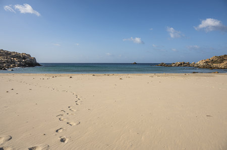 The beautiful beach of Cala Cipolla in Chia in Sardinia, with white sand and transparent and turquoise waterの写真素材