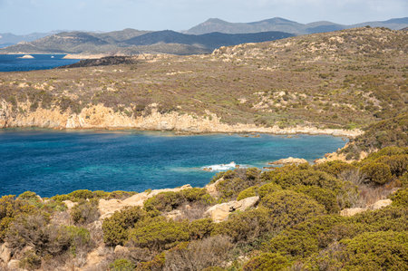 Landscape of the south-west coast of Sardinia with cliffs, blue sea, fjords and white cloudsの写真素材