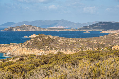 Landscape of the south-west coast of Sardinia with cliffs, blue sea, fjords and white cloudsの写真素材