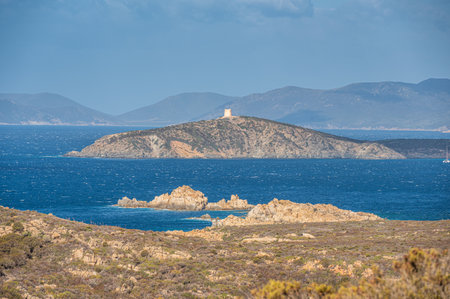 Landscape of the south-west coast of Sardinia with cliffs, blue sea, fjords and white cloudsの写真素材