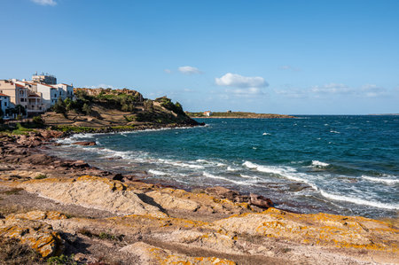 Coastline of Sant'Antioco Island with high red cliffs and rough seaの写真素材