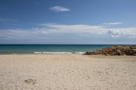 The beautiful beach in Sardinia with fine sand and blue and turquoise water and storm clouds on the horizonの写真素材