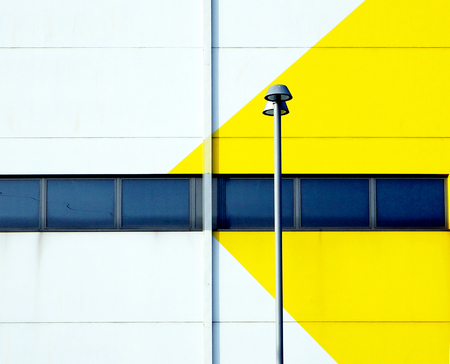 street lamp in front of a yellow amd white buildingの写真素材