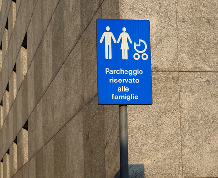Family only parking sign on a gray building backgroundの写真素材