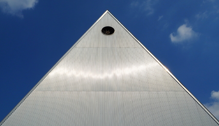 Industrial building of pyramid-shaped, made of aluminum panelの写真素材