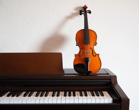 Violin leaning on a digital pianoの写真素材