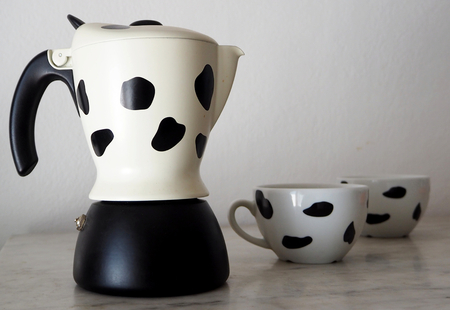 Coffee maker with two black and white cappuccino cupsの写真素材