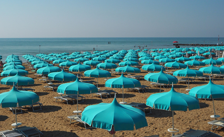 Blue umbrellas lined up in an Adriatic seaの写真素材