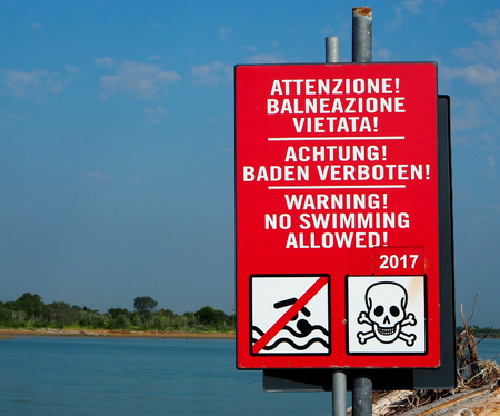 No swimming sign with skull icon, written in english, german and italianの写真素材