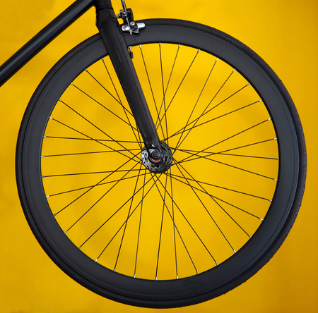 Carbon wheel for road bicycle on a yellow backgroundの写真素材