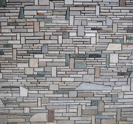 Modern wall made with stones of different shapes, sizez and colors.