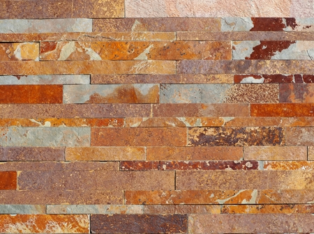 Modern granite stone wall, made of bricks of different shades. Background and texture.