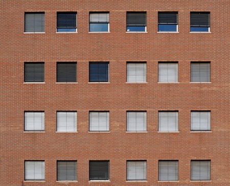 Brick wall facade of modern building with square windows