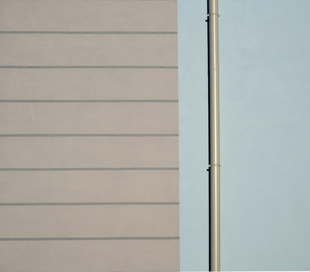 Minimal abstract and urban. Architectural detail of an exterior wall with gutter and light colorsの写真素材