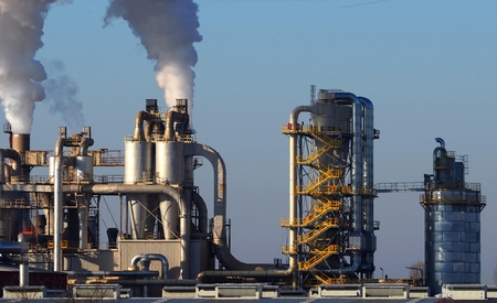 Industrial buildings with smoke stacks, pipes, staircases and silosの写真素材
