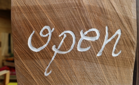 Open. Rustic signpost for the store written in white on wood backgroundの写真素材