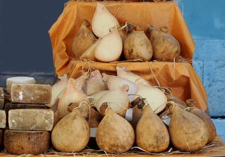 Caciocavallo, a type of stretched curd cheese from south italy, on a rural market shelf