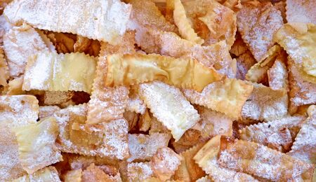 Handmade Crostoli or Chiacchiere, traditional italian carnival pastry. Food background and texture