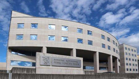 Udine, Italy. March 7, 2020. The headquarters of the autonomous region of Friuli Venezia Giulia in Udine under a blue sky with cloudsのeditorial素材