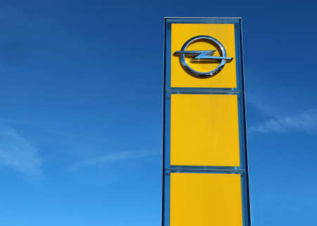 Reana del Rojale, Italy. March 22 2019. Opel logo outside the car dealership of the area, against a blue sky with clouds. It is the symbol of the german multinational car manufacturerのeditorial素材