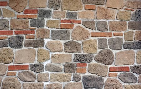 Stone wall cladding made of stoneware with rocks and bricks effect. It is used for exteriorの写真素材