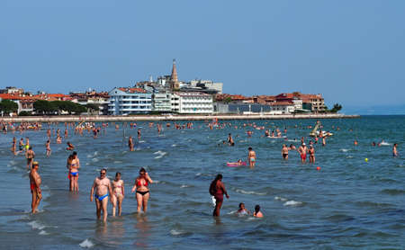 Grado, Italy. June 15, 2019. Grado beach with the townscape of the city on behind, at the opening of the summer holiday seasonのeditorial素材