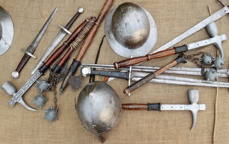 Medieval weapons and helmets on jute canvas. Top view.の写真素材