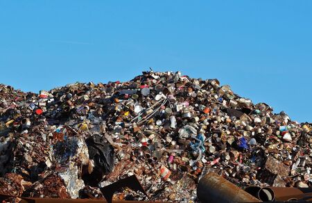 Big pile of cans, aluminum and scrap ferrous material under the sun, waiting to be recycled.の写真素材