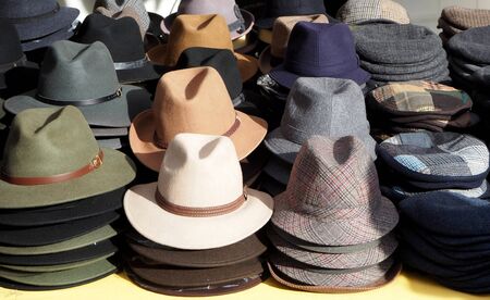 Different models of men's hats on a store shelfの写真素材