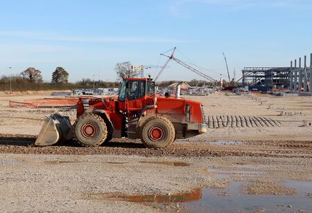 Wheel loader machine at work in a construction site of a new industrial development areaの写真素材