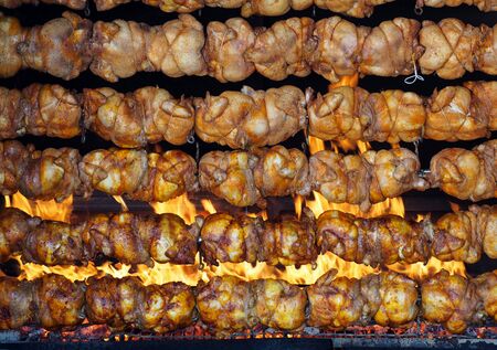 Roasted chickens grilled on rotating spit over the flames. Rotisserieの写真素材