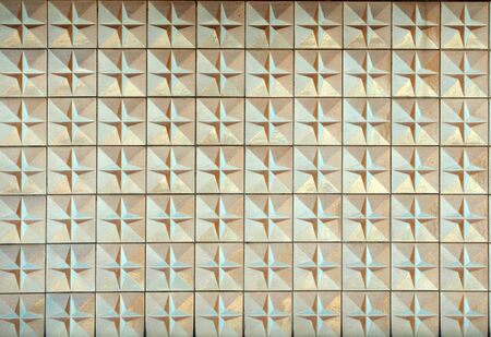 Old weathered vintage sixties tiles with faded colors and raised geometric patterns, Background and...