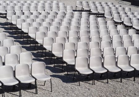 Many empty plastic chairs geometrically arranged. Texture and background.の写真素材