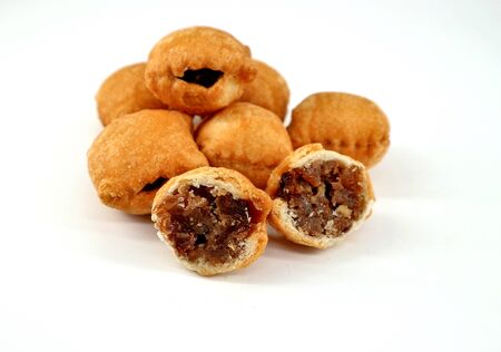 Strucchi, or struklji, a dessert typical of the Slovenian minority in Italy, on white background. It is made of shortbread stuffed with walnuts, hazelnuts, pine nuts and raisinsの写真素材