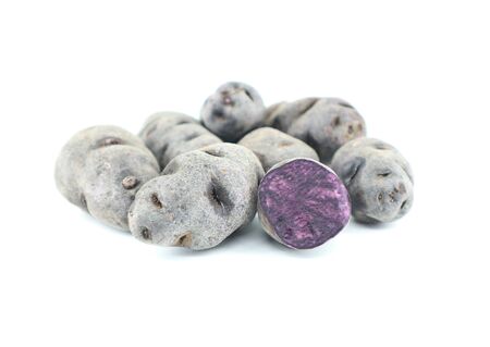 Purple potatoes on white background, close up.の写真素材