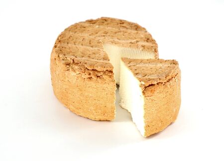 Smoked ricotta cheese wheel, or cottage cheese, on white background.の写真素材