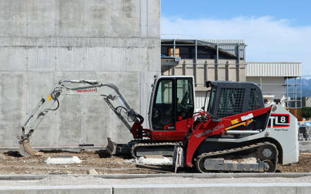 Udine, Italy. May 17, 2020. Brand new Takeuchi mini excavator and mini bulldozer at work in a construction site during a redevelopment of an industrial areaのeditorial素材