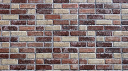 Cladding wall made of stoneware panels with multi colored bricks effect. Background and texture
