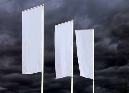 Three white blank banners against a dramatic stormy dark sky. Background for copy spaceの写真素材