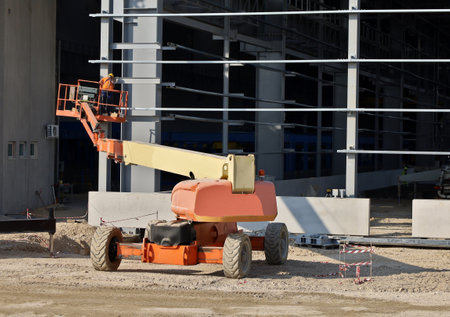 Cherry picker at work on a frame of a commercial building under constructionの写真素材