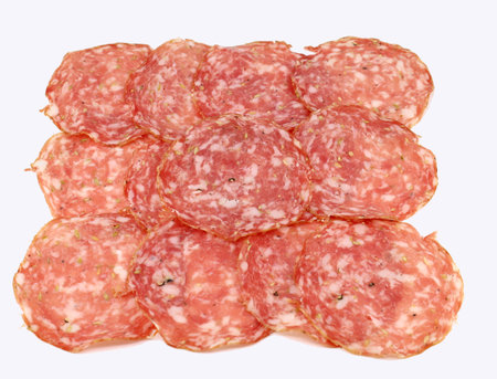 Slices of Finocchiona on white background. It is a traditional salami from Tuscany charaterized by the use of fennel seeds.の写真素材