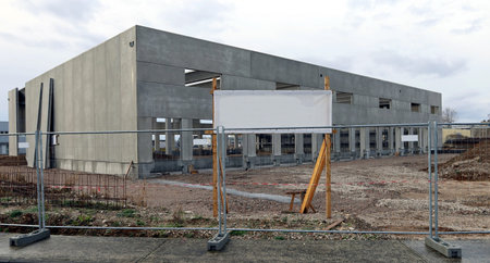 Blank information board outside the construction site, where they are building a new industrial...