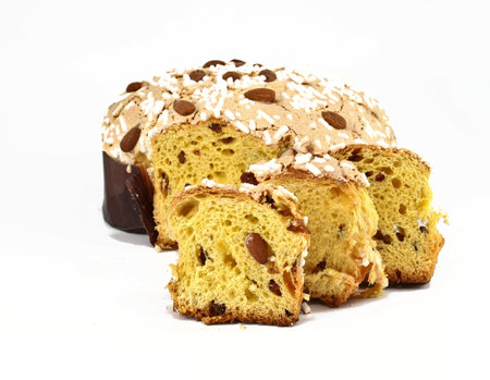 Colomba Pasquale, typical italian easter cake, with some slices in front. The name means Easter Dove in english language, due to its shape. White background.の写真素材