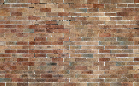 Vintage brick tiled wall with different shades of brown. Background and texture