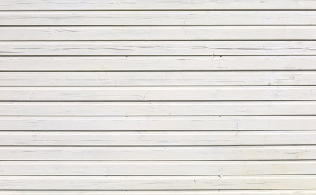 White painted wood paneling with horizontal strips under the sunlight. Background and texture, copy space.の写真素材